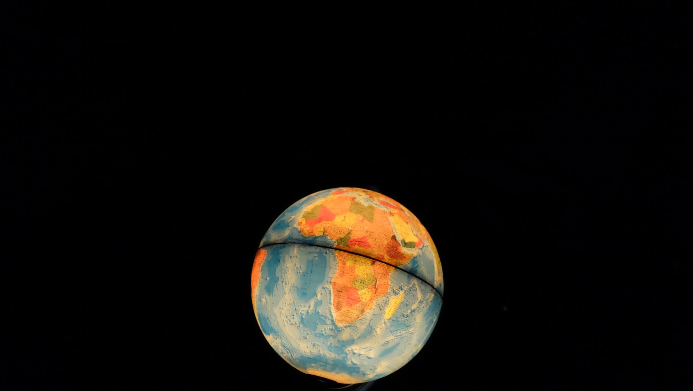 Globe Made of Maps Against Black Background